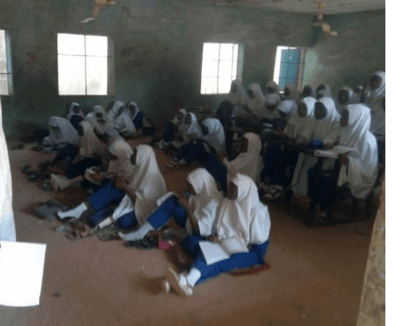 Students Take Classes Sitting On The Floor As School Removes Chairs