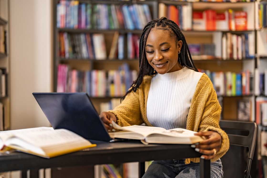 A university student using a laptop while studying.