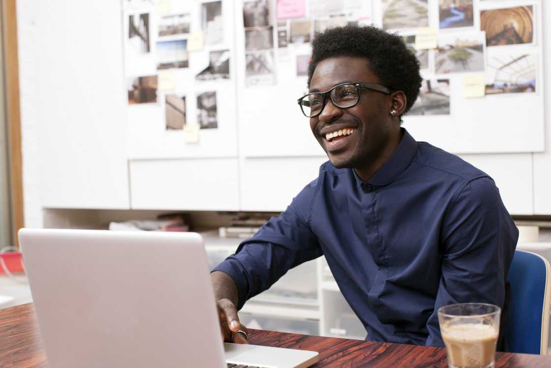 A young man working at his desk.