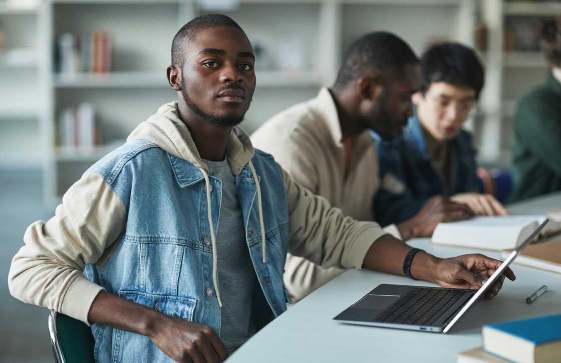 A university student using a laptop in class