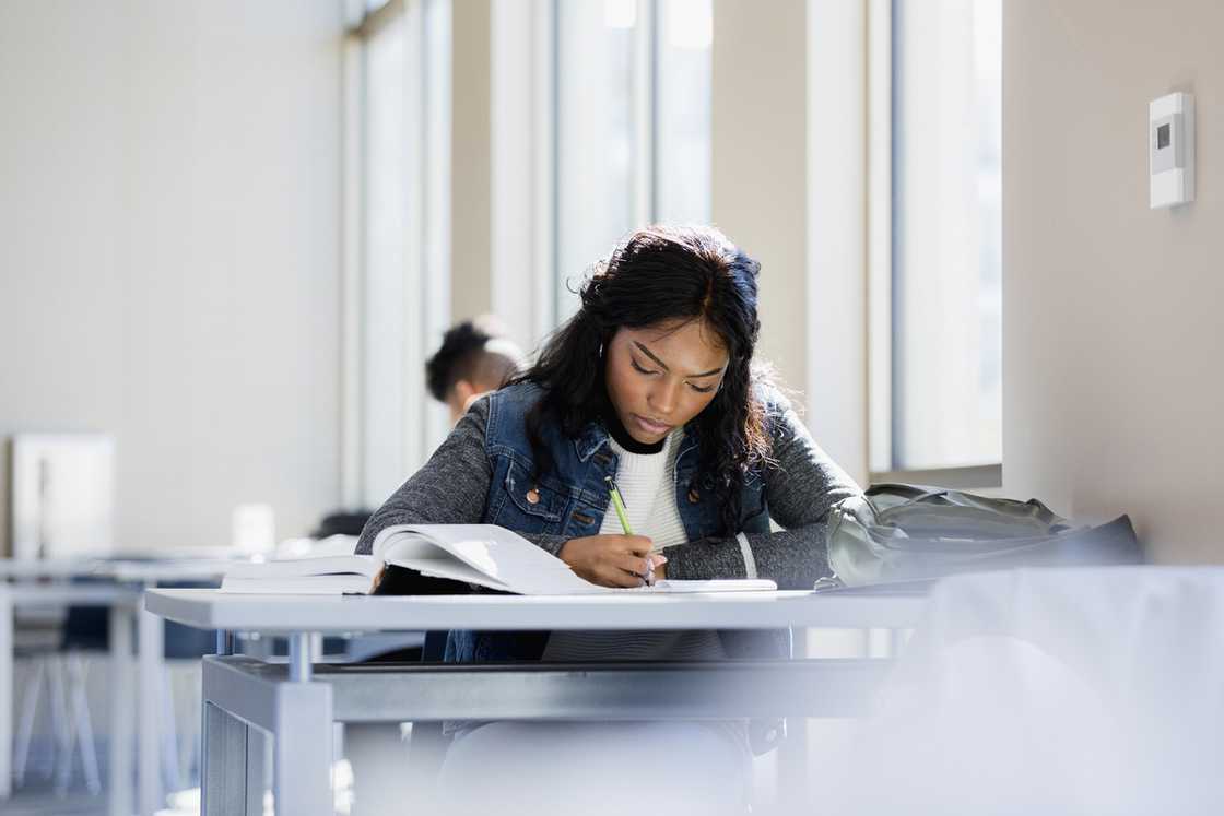 A female student studies in a library.