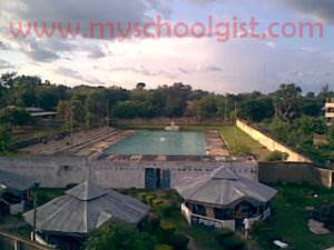 A portion of the Pepsi Gardenbehind Queen Amina Hall with the the swimming pool behind it