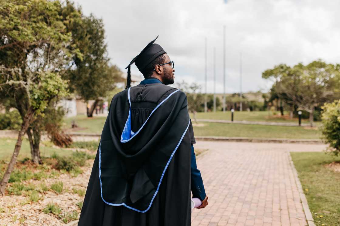 A male graduate in a graduation gown