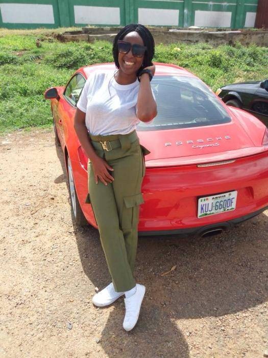 Viral Photo of Female Corper Who Stepped Out With a Porsche For Clearance in Abuja