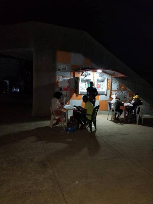 OAU Students Pictured Reading Outside, Due to the Nationwide Blackout